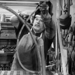 man measuring steel table welding Made in America factory