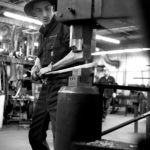 man forging steel hammering Made in America factory